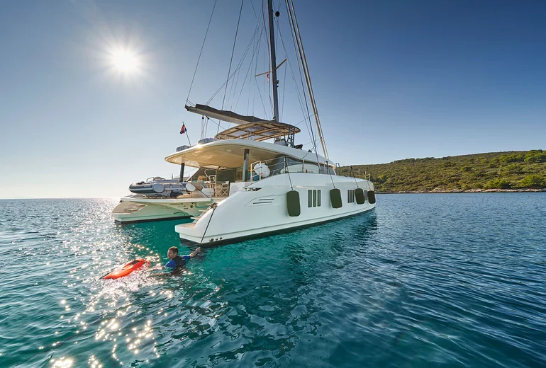 Catamaran at anchor in a quiet Greek cove