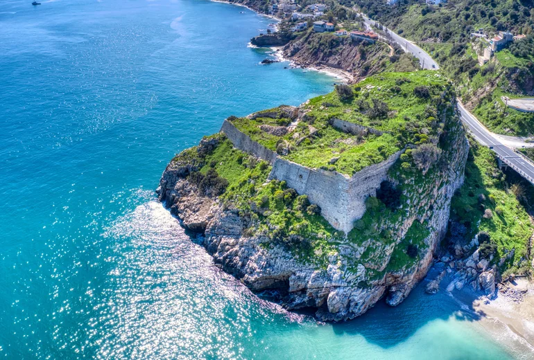 Ios island bay and white village on the cliff