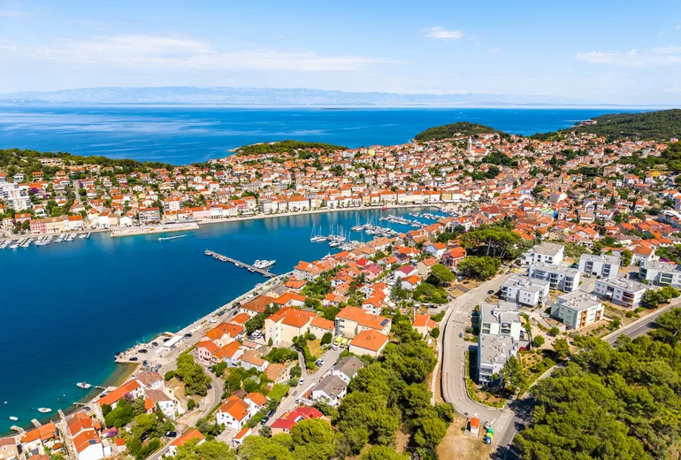 Aerial of Mali Losinj town surrounding its long harbor bay, Croatia