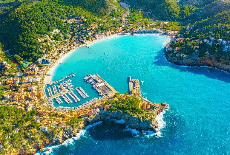 Aerial of Port de Soller horseshoe bay with marina and beach, Mallorca