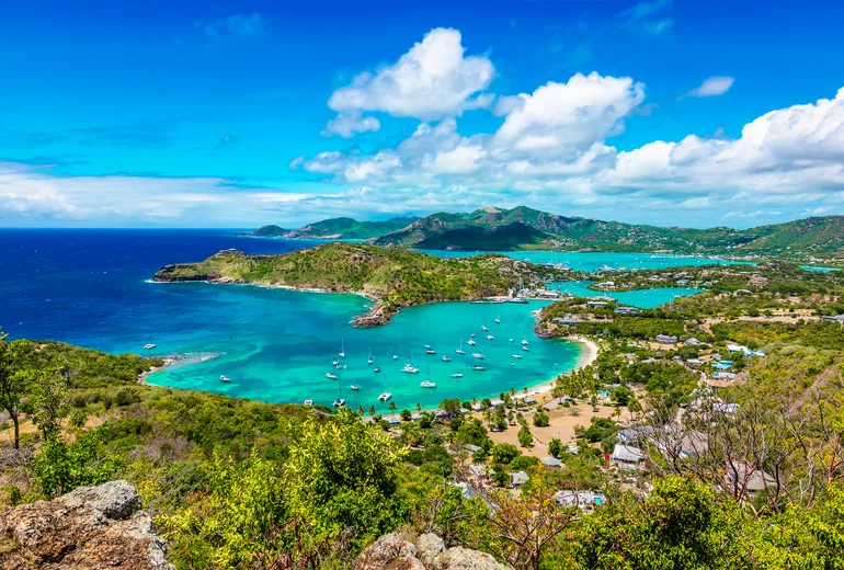 View over English Harbour, Antigua, with anchored yachts and green hills